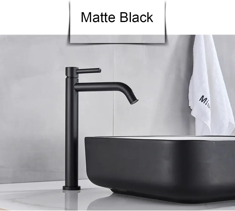 Matte black basin faucet with tall cylindrical body, single lever, and curved spout beside a black sink
