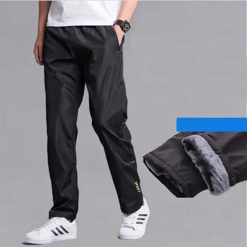 Men's black fleece-lined sweatpants with zip pockets and a loose straight fit.