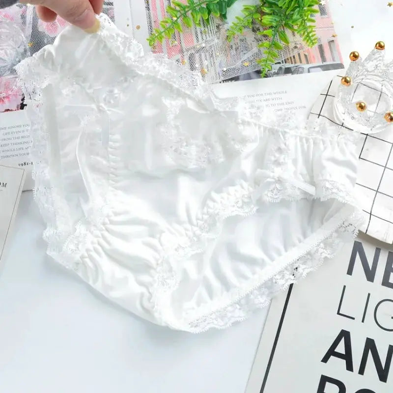Panties by Simples Market, white satin with lace trim and a low-waist design.