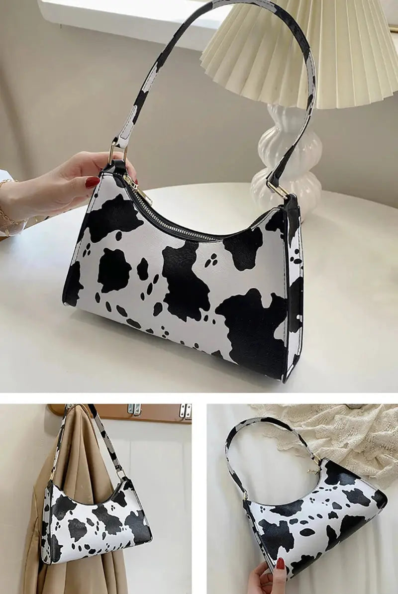 Cow-print PU leather shoulder bag with gold-tone hardware and top zipper