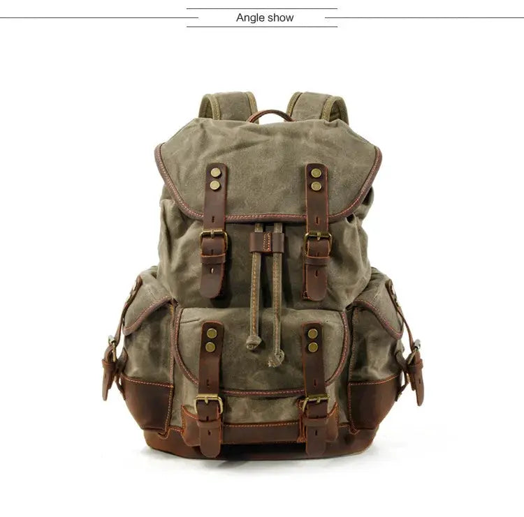 Vintage canvas backpack with brown leather straps and buckles, large waxed rucksack for travel.