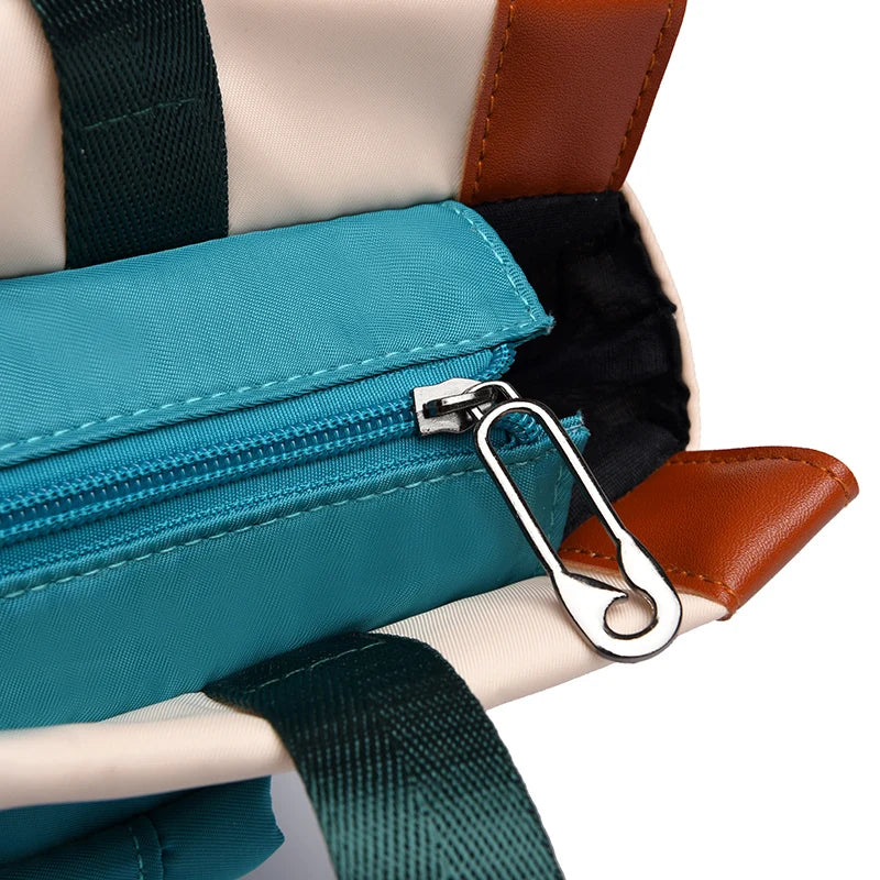 Women’s teal waterproof Oxford backpack with brown faux leather accents