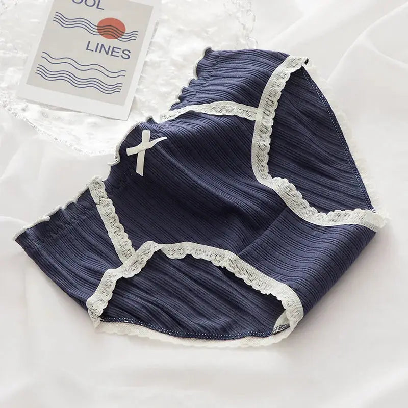 Cotton women's navy panties with white lace trim and bow at mid-waist.