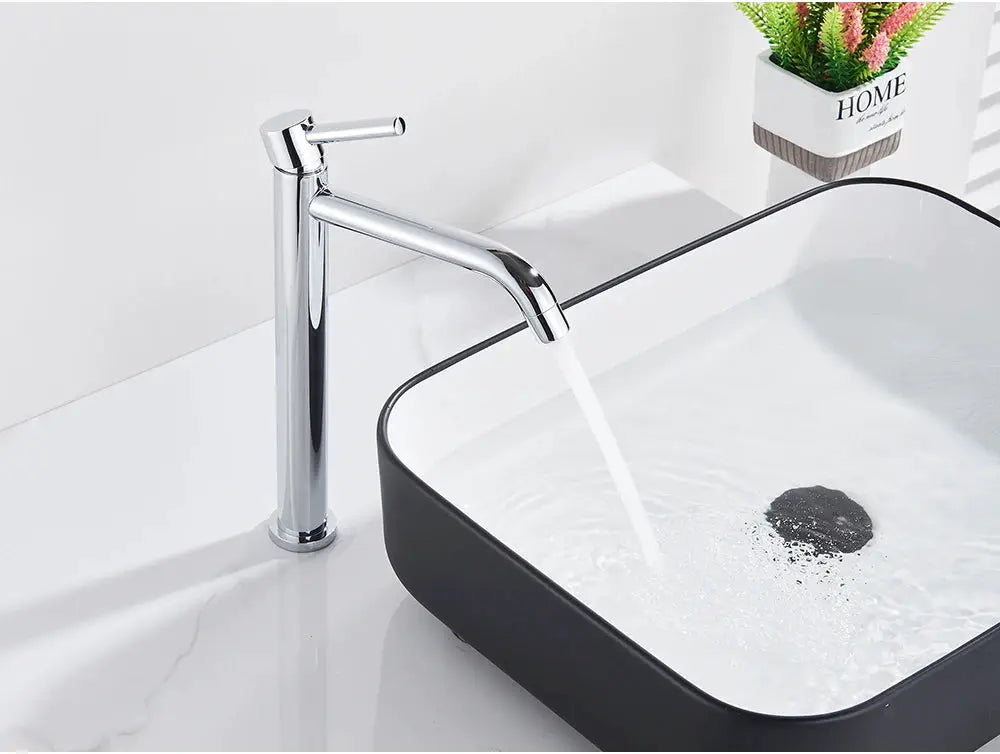 Chrome bathroom basin faucet with lever handle over a square black washbasin
