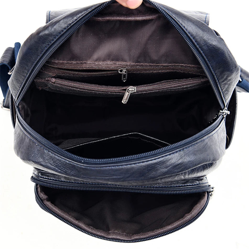 Genuine women soft leather backpack navy blue with multiple interior zip pockets.