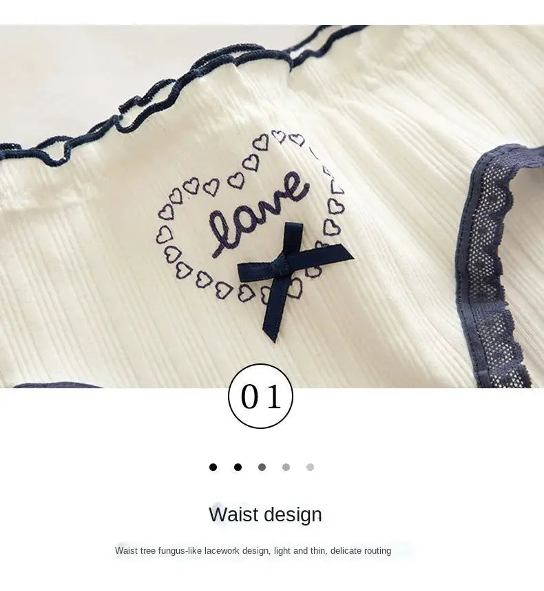 Cotton women's mid-rise underwear featuring navy lace trim, cream fabric, heart embroidery and bow.