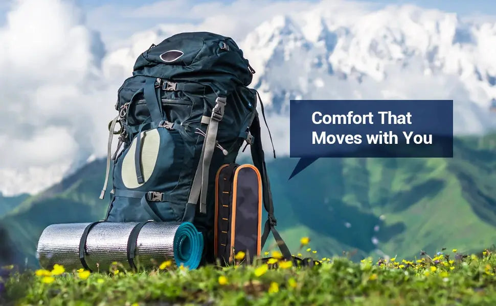 Camping backpack with sleeping mat and gear in a scenic mountain meadow.