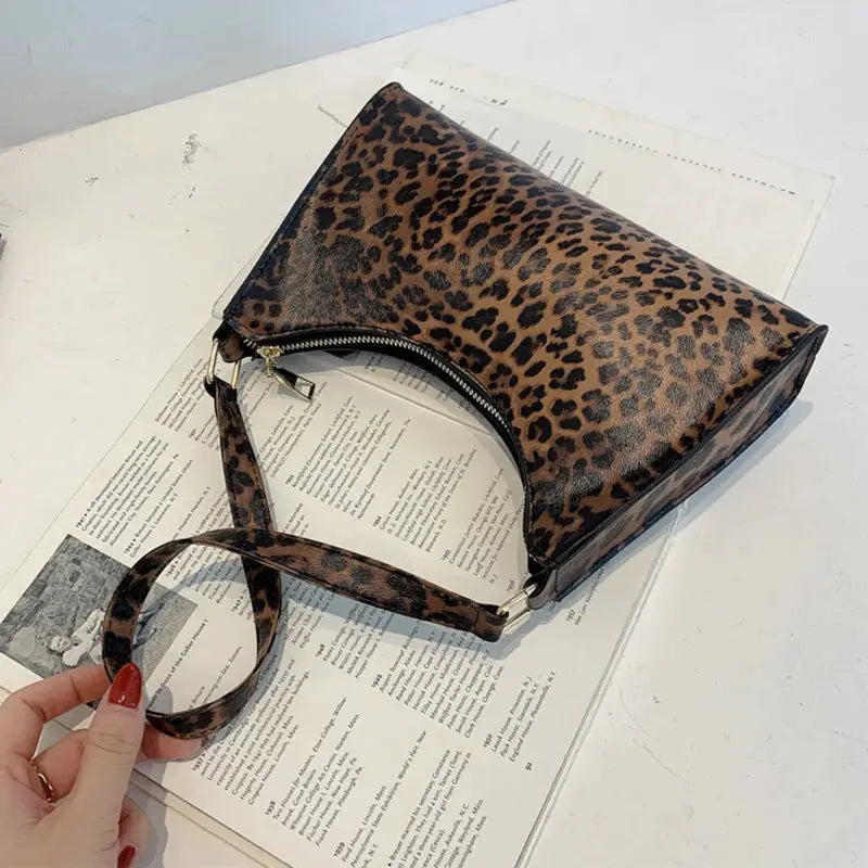 Leopard print PU leather shoulder bag with zip closure and crossbody strap