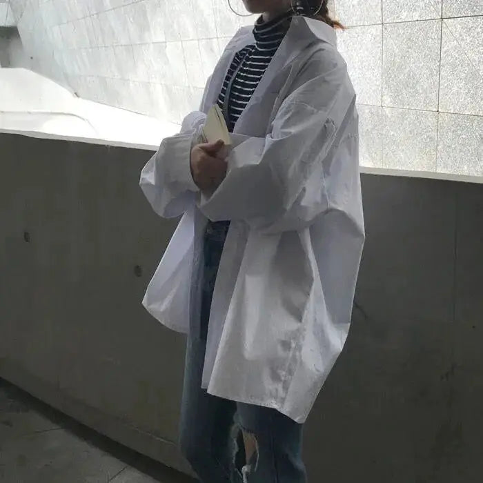 Zadily oversized white shirt blouse by Simples Market, long-sleeve, open-front tunic worn over striped top.