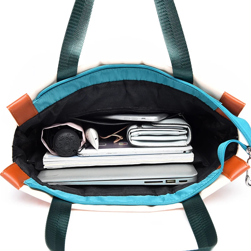 Women's teal waterproof Oxford backpack by Simples Market, large-capacity with brown accents, opened to show laptop and notebooks