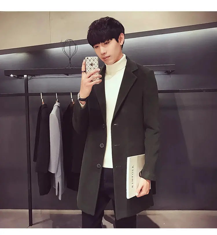 Men's long dark green wool-blend coat with notched lapels on model; casual business, slim fit.