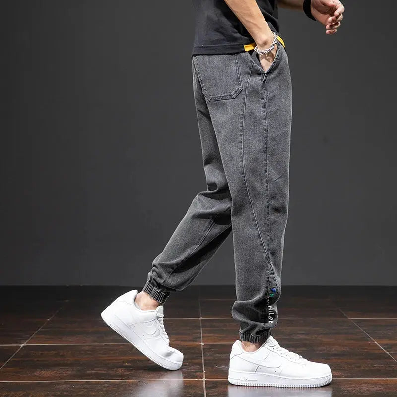 Men's gray cargo denim jogger pants with elastic cuffs and relaxed fit