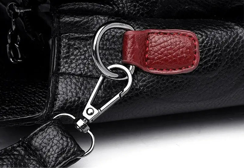 PU leather crossbody bag by Simples Market with silver hardware and red strap accent.