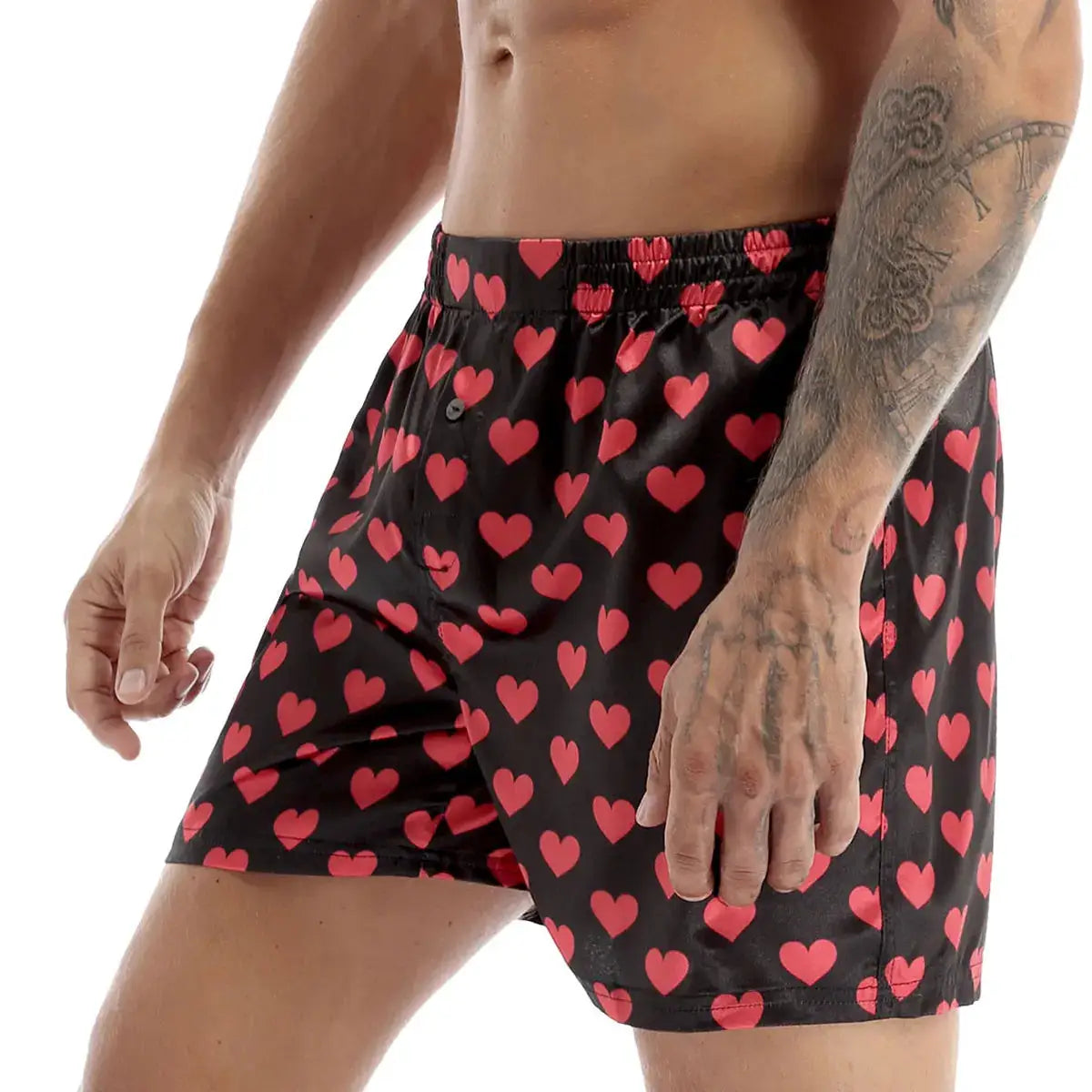 Mens heart-print boxer shorts in soft black fabric with red hearts; lightweight, loose-fit beachwear