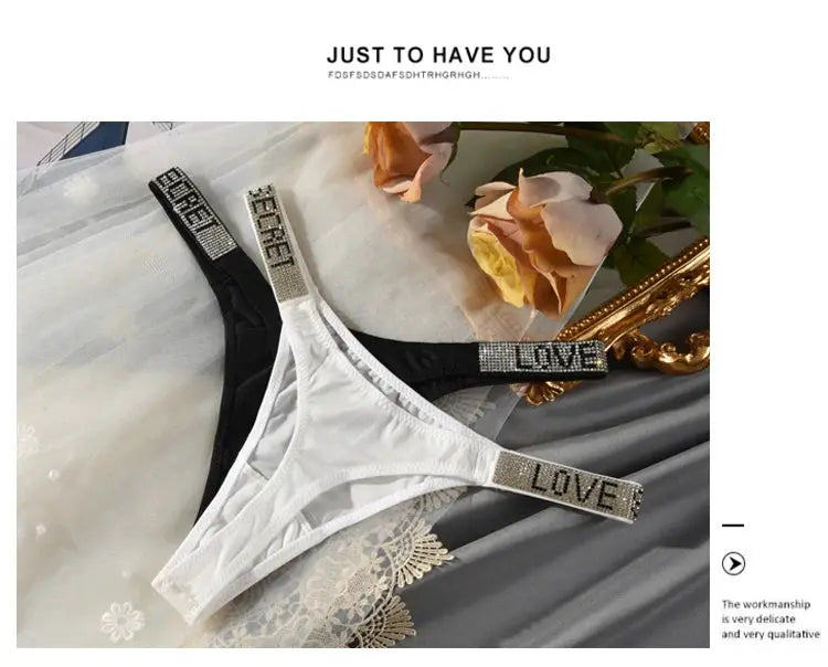 Two white and black low-waist rhinestone thongs with LOVE and FOREVER letter straps by Simples Market