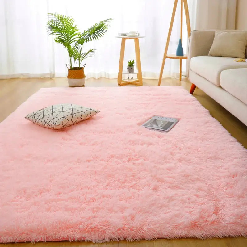 Pink fluffy shag rug 160x230 cm for living room with gray geometric pillow nearby