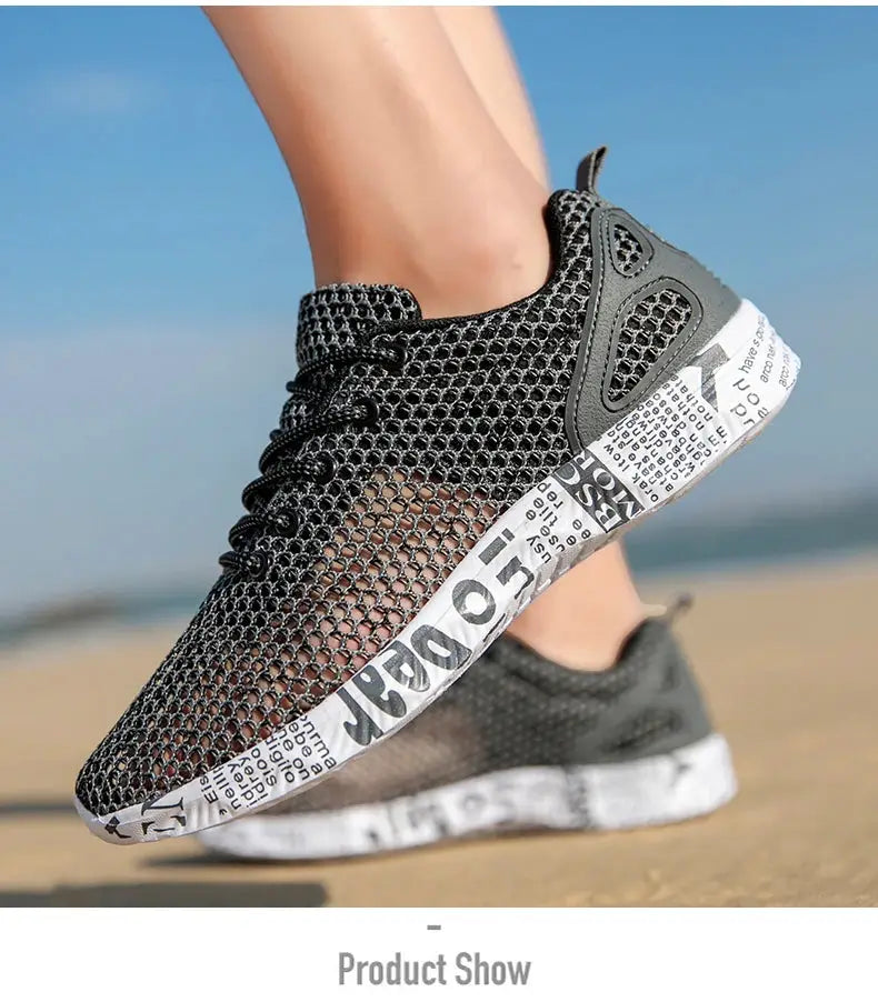 Two water shoes for men, black mesh upper with foam sole on the beach