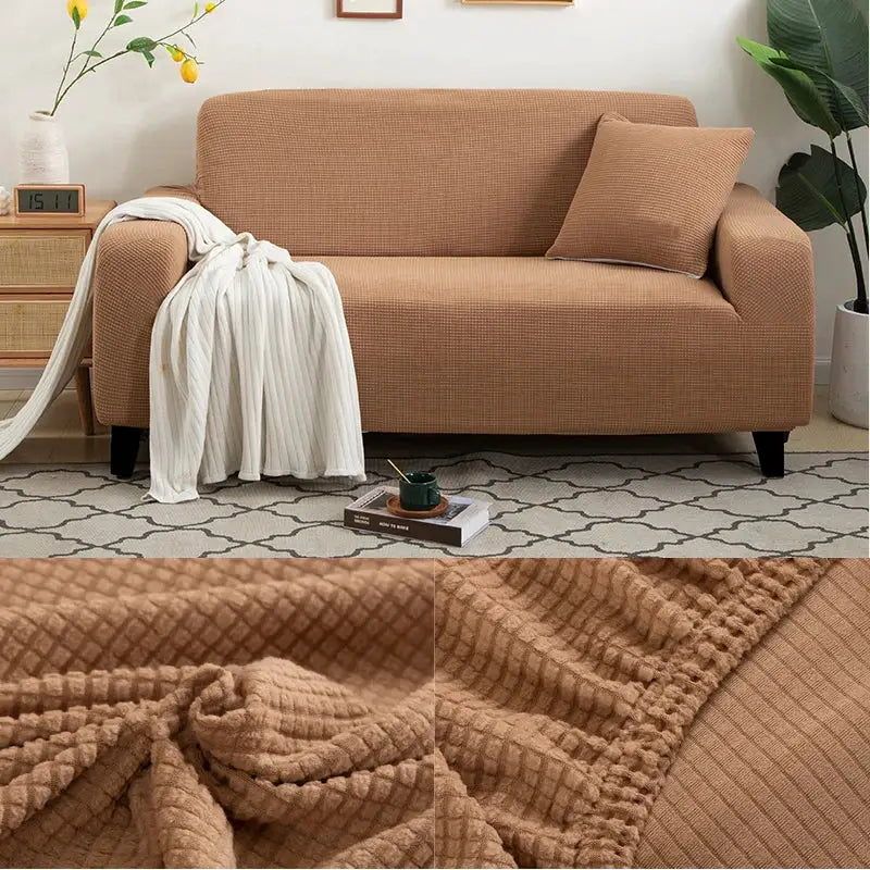 Thick jacquard sofa protector cover in tan on an L-shaped living room couch with textured weave.