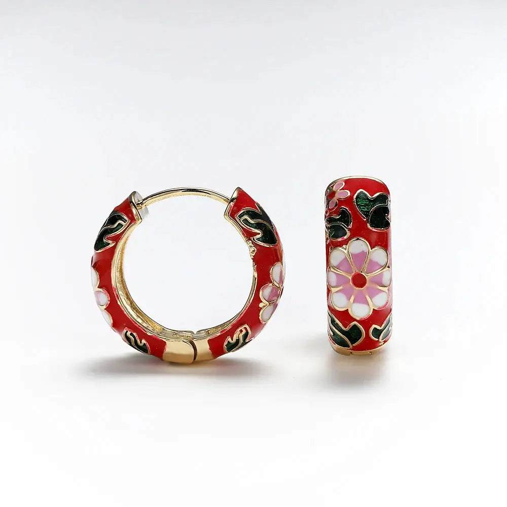 Two-piece red enamel flower earring set with gold-tone trim; round hoop and matching huggie with white petals