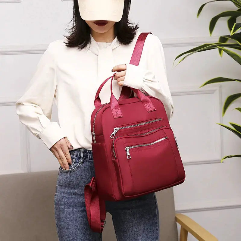 Women’s backpack red waterproof Oxford travel bag with multiple zip pockets and top handles