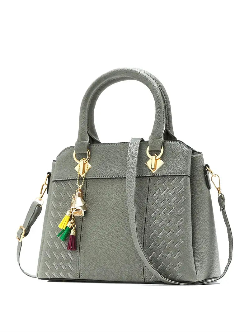 Women's handbag with tassel charms, gray PU leather tote featuring top-handle and crossbody strap