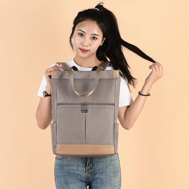 Backpack, grey waterproof Oxford bag with beige base and tan straps
