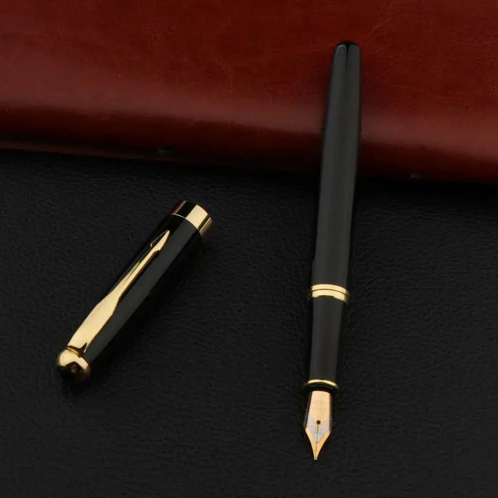Black metal fountain pen with gold trim; cap off and nib exposed.