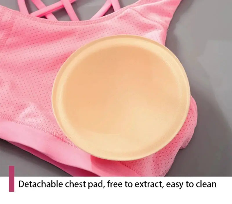 Pink women's fitness sports bra with cross-back straps and detachable chest pad