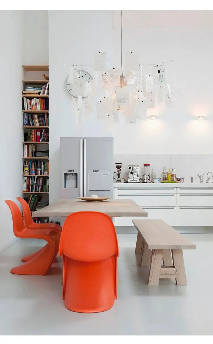 Ingo Maurer colored paper chandelier replica by Simples Market, LED E27 lamp, hanging paper pieces above dining table.