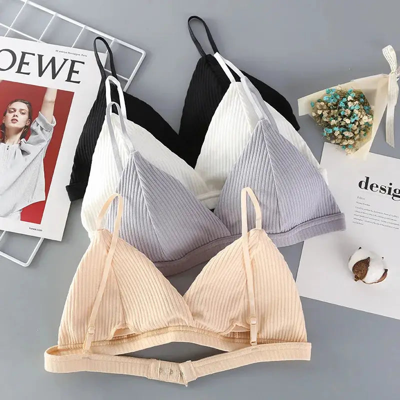 Four ribbed cotton bralettes with triangle cups; wire-free, low-back, in peach, lavender, white, and black.