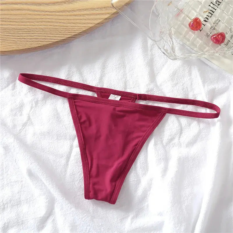 Burgundy thong underwear with thin side straps, low-rise T-back style.