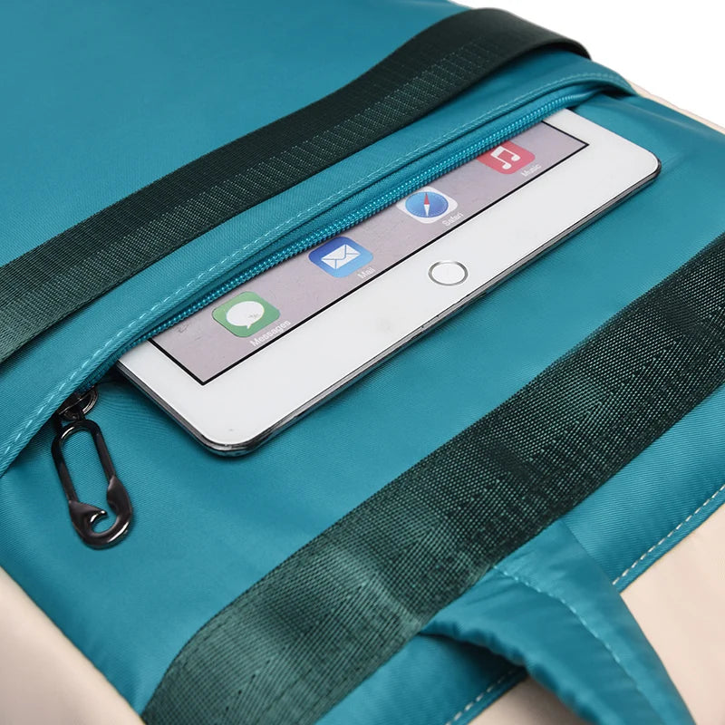 Women backpack turquoise waterproof Oxford bag with front zip pocket holding a smartphone
