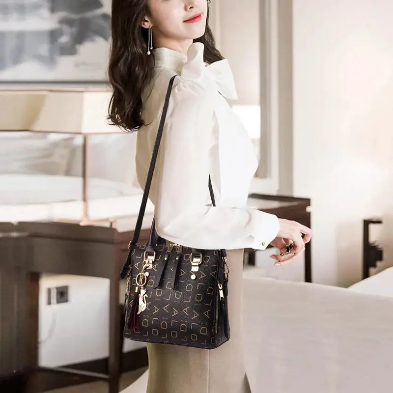 Fashion English Letter handbag in black PU leather with tassel, top-handle design and gold hardware