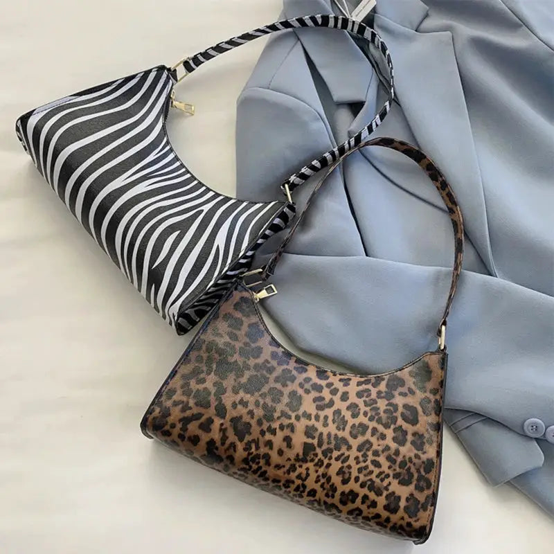 Two women's shoulder bags in zebra-striped PU leather and leopard print with matching straps