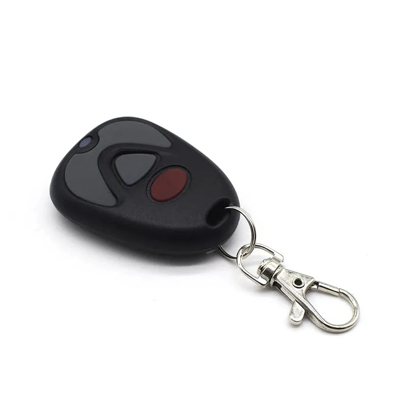 Simples Market garage door remote control, black oval transmitter with gray and red buttons on a keyring clip