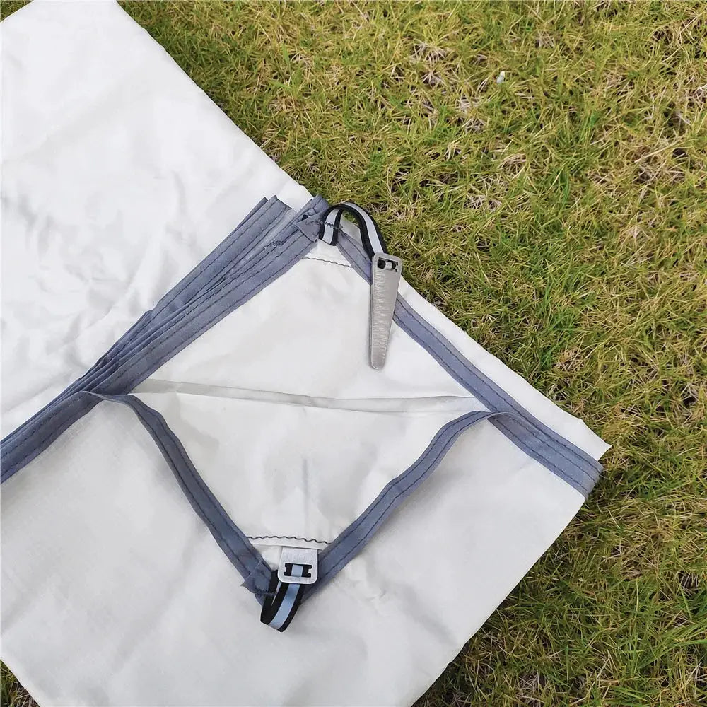 Waterproof camping mat with pegs, white fabric with gray trim, ultralight large portable travel mat.