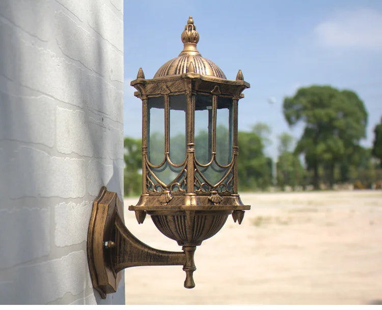 Simples Market antique bronze outdoor wall lantern with glass panels mounted on a wall bracket