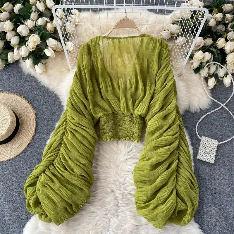 Draped chiffon blouse in olive green with oversized puff long sleeves and smocked waistband.