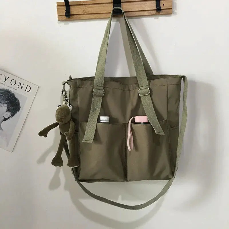 Waterproof Oxford large-capacity olive-green women's handbag with dual handles and crossbody strap.