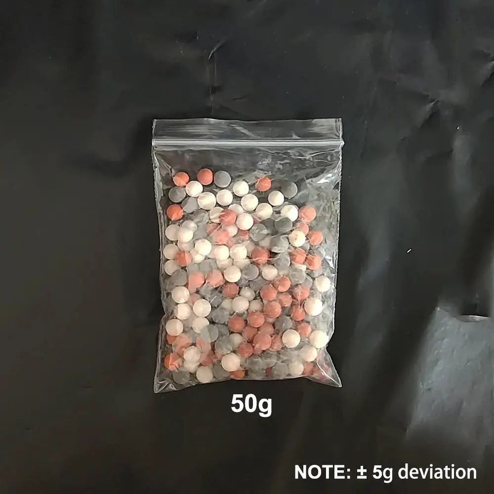 Shower head replacement beads by Simples Market in a clear 50g bag of pink, white, and gray ceramic balls