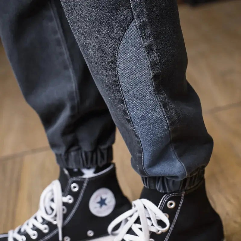 Plus-size men's denim cargo joggers with blue side panels and elastic ankle cuffs