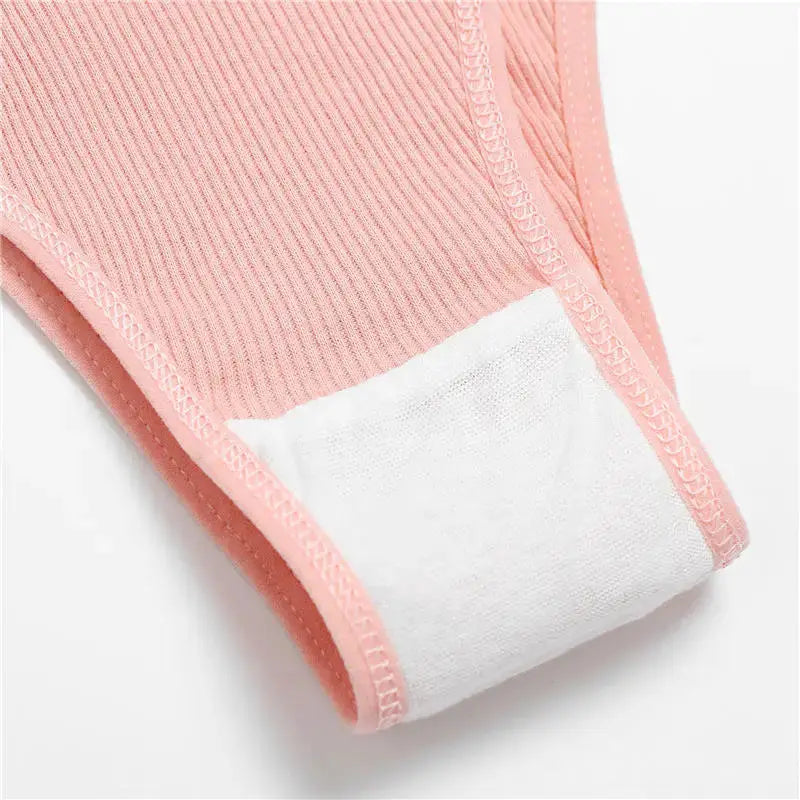 Pink cotton ribbed women's panties bikini brief with white gusset lining, close-up