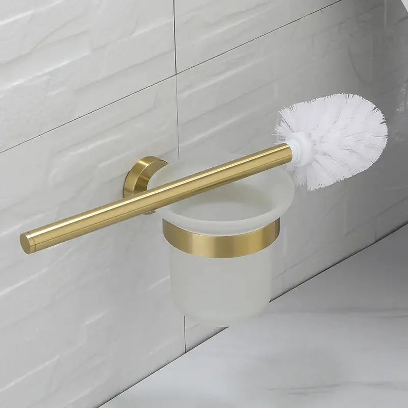 Brushed gold wall-mounted bathroom hardware set with toilet brush and frosted cup holder