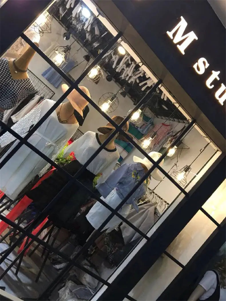 Industrial retro iron art pendant light in a clothing store window display