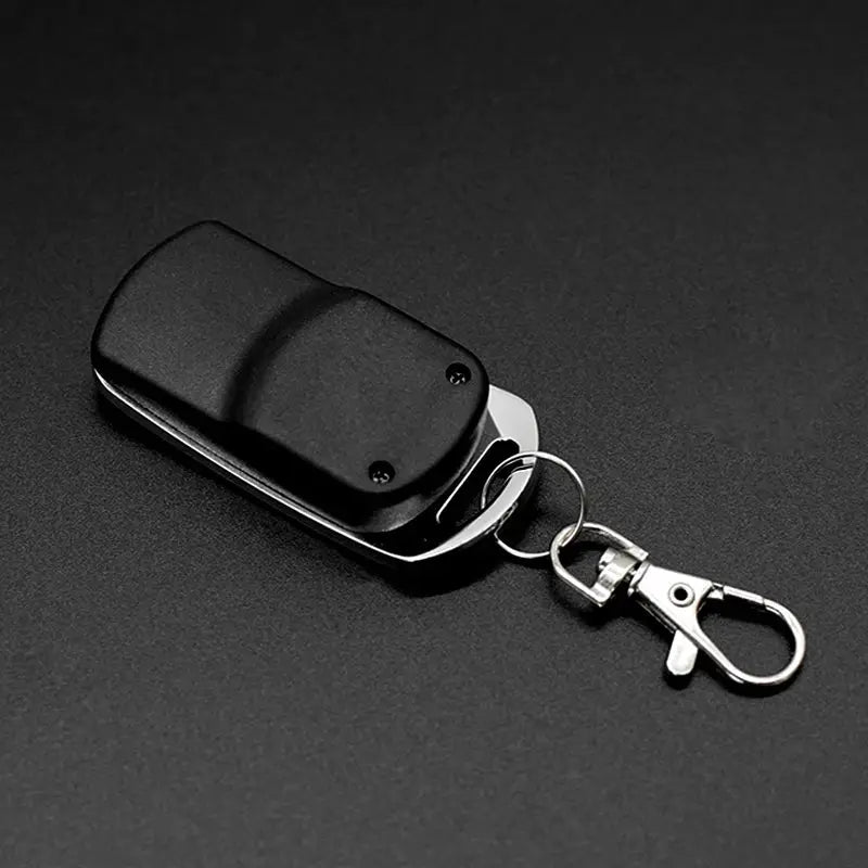 4 in 1 garage remote key fob transmitter, black plastic housing with metal clip and keyring