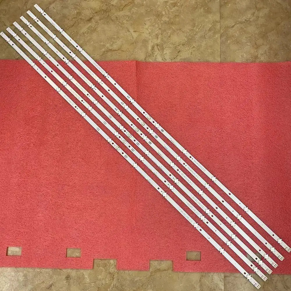 LED backlight strips for TV, 6 white strips laid diagonally on a red surface