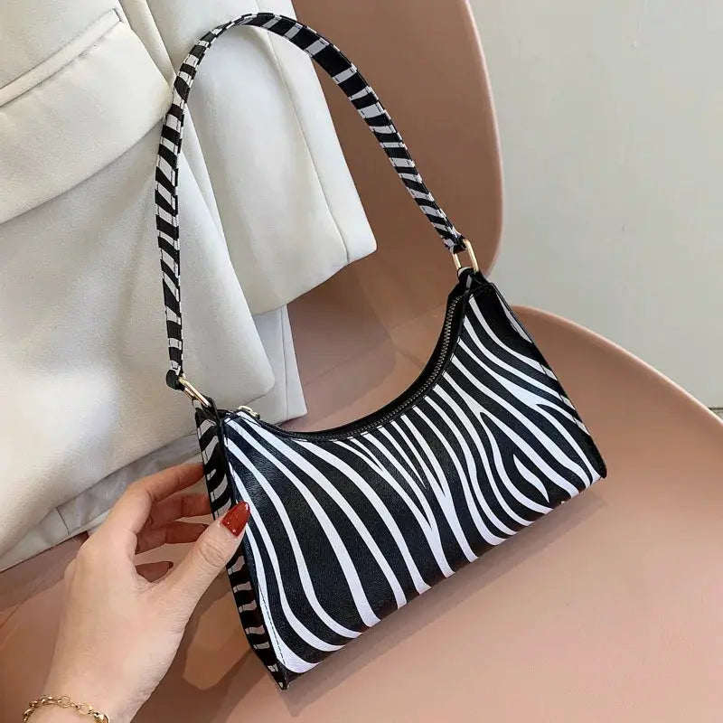 Shoulder bag in zebra print PU leather with striped strap