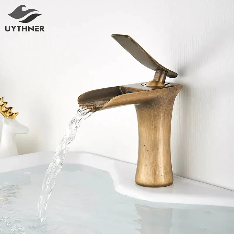 Basin faucet antique brass finish with waterfall flow and single-handle lever; UYTHNER logo visible.