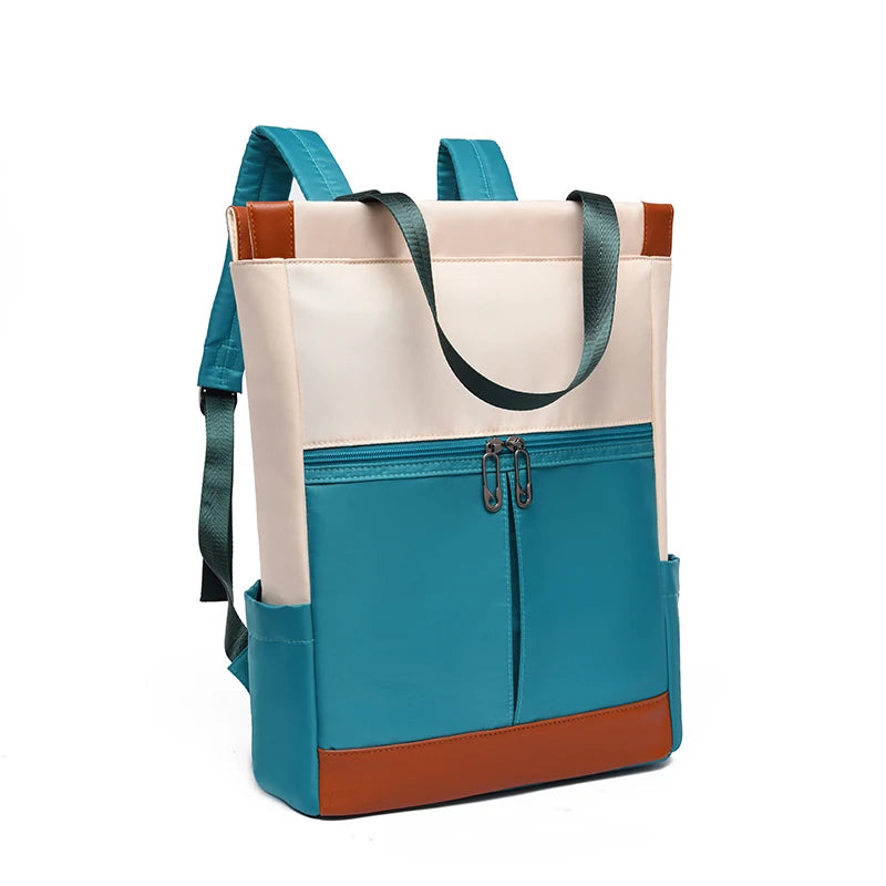 Women’s waterproof Oxford backpack in teal with cream top, brown bottom, front teal zip pocket and teal straps