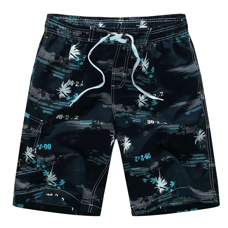 Men's surf board shorts with black base and teal palm tree print, white drawstring waist.